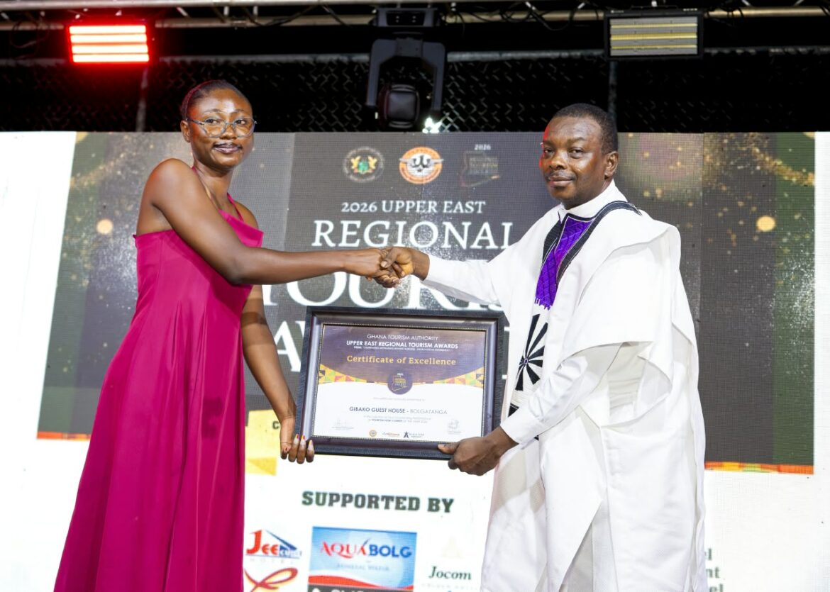 Representative of Gibako Guest House receiving the award